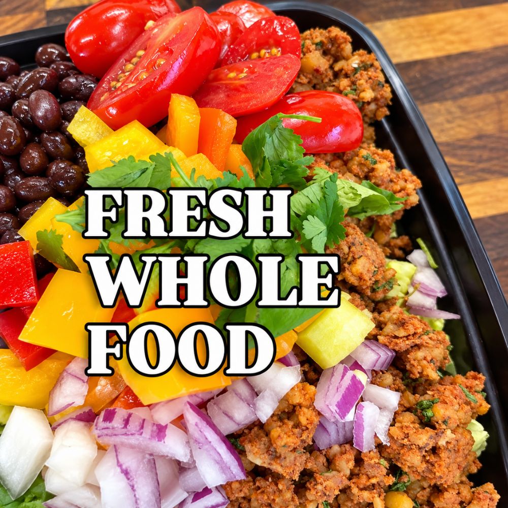 Fresh whole-food bowl with black beans, sliced tomatoes, colorful bell peppers, red and white onions, fresh cilantro, and seasoned plant-based protein, with text reading ‘Fresh Whole Food.
