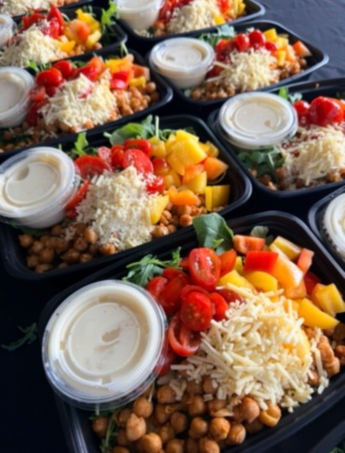 Orzo Pasta Bowl with lemon-dill orzo pasta, arugula, seasoned chickpeas, green beans, seared zucchini, bell pepper, tomatoes, vegan parmesan, and lemony dressing. 
